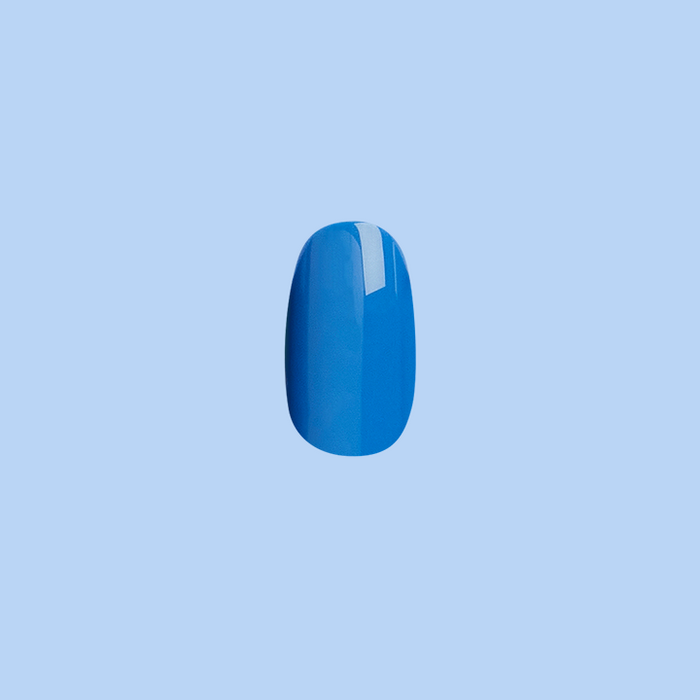 Blue Canoe | Round | Short press-on nail in medium denim blue with glossy finish on light blue background