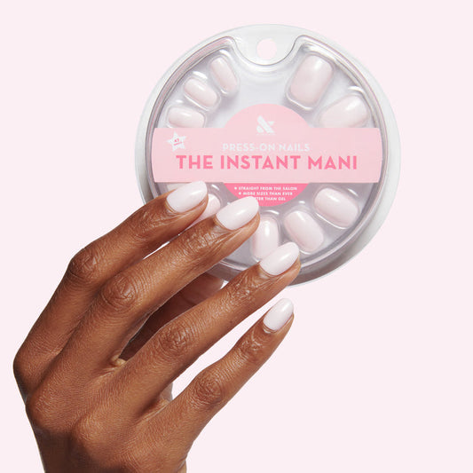 Hand with extra short round sheer pink press-on nails from CCT | Round | Extra Short for easy at-home mani