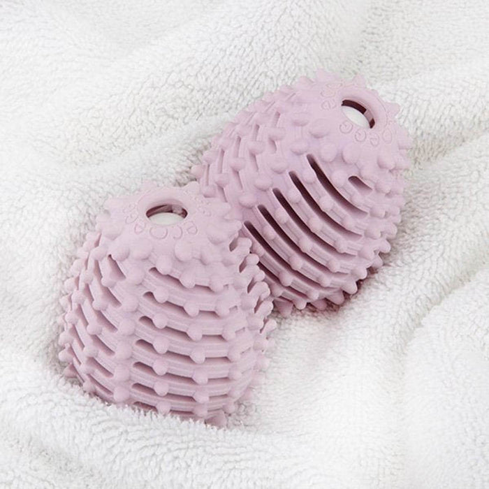 Two purple textured balls on a white towel.