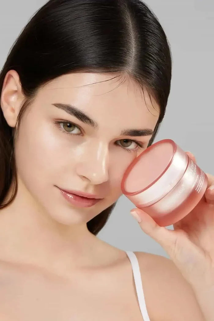 Model holding the Medicube Triple Deep Collagen Cream, showcasing a radiant, firm, and healthy complexion.
