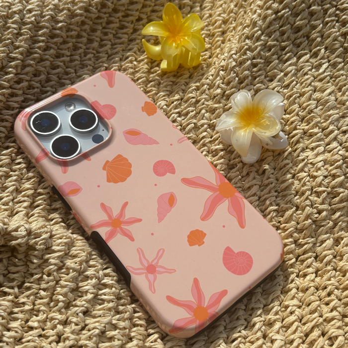 Pink floral phone case and white mini Tropical Flower claw clip on woven fabric.