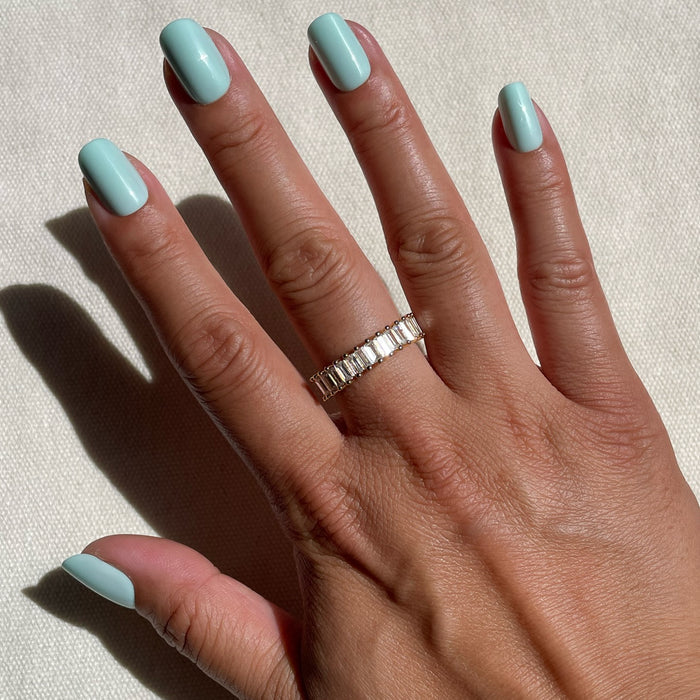 Hand featuring Sleeping Bag | Squoval | Short in pastel mint green press-on nails illuminated by natural sunlight