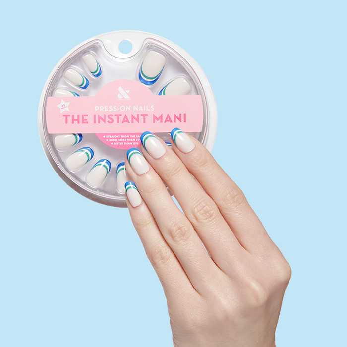 Hand with Triple French | Round | Short press-on nails featuring blue and green triple french tips against pale blue background