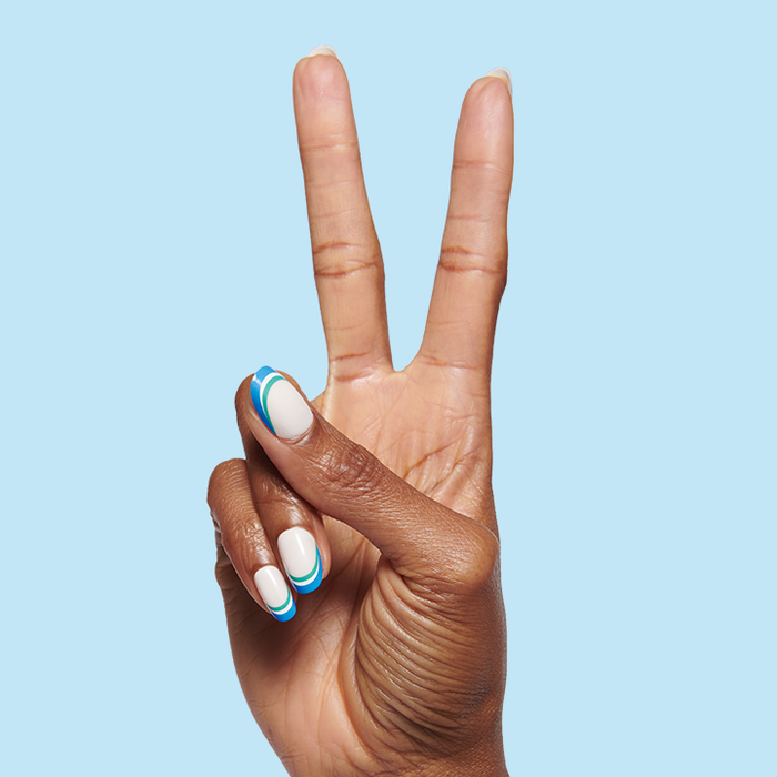 Hand showing peace sign with Triple French | Round | Short press-on nails in blue and green on pale base