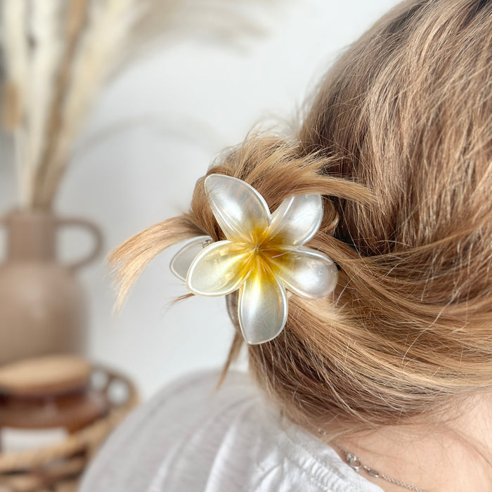Woman’s bun held by a white Tropical Flower Claw Clip from Coconut Lane.