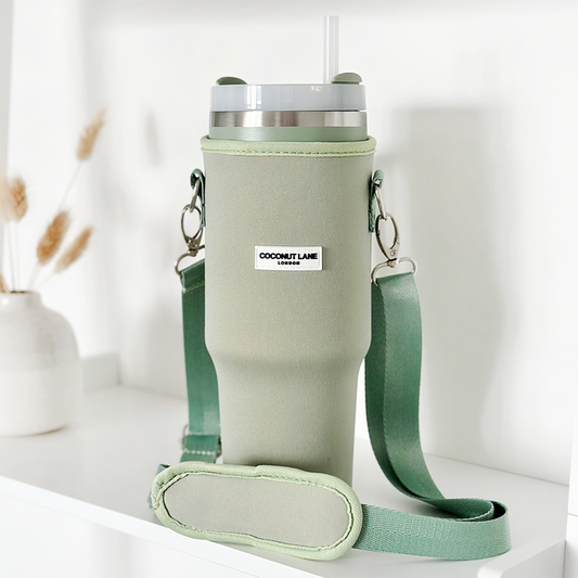 Soft sage tumbler with matching neoprene sleeve, carrying strap, and straw.