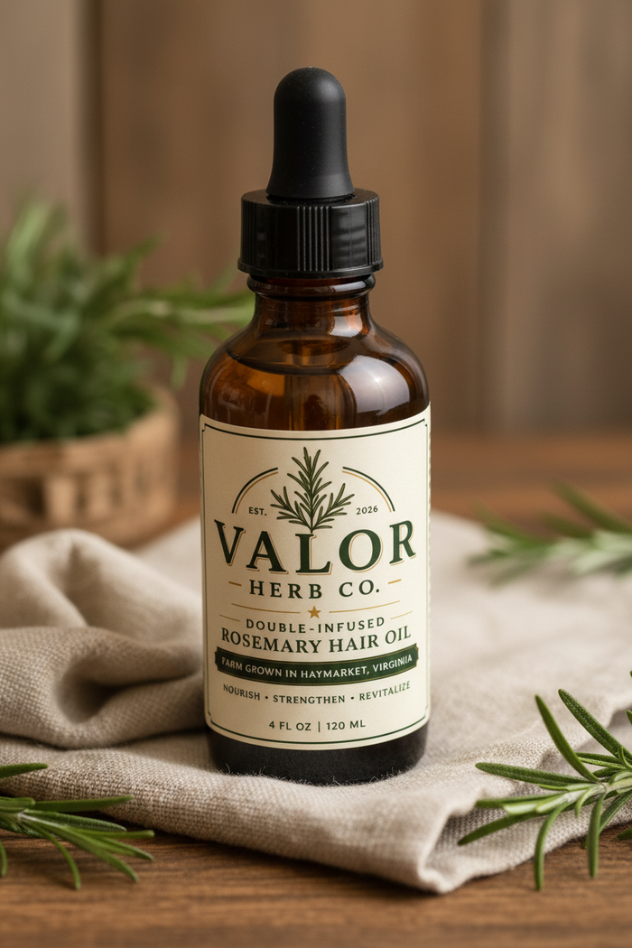 Bottle of Valor Herb Co. rosemary hair oil on a wooden surface with herbs in the background